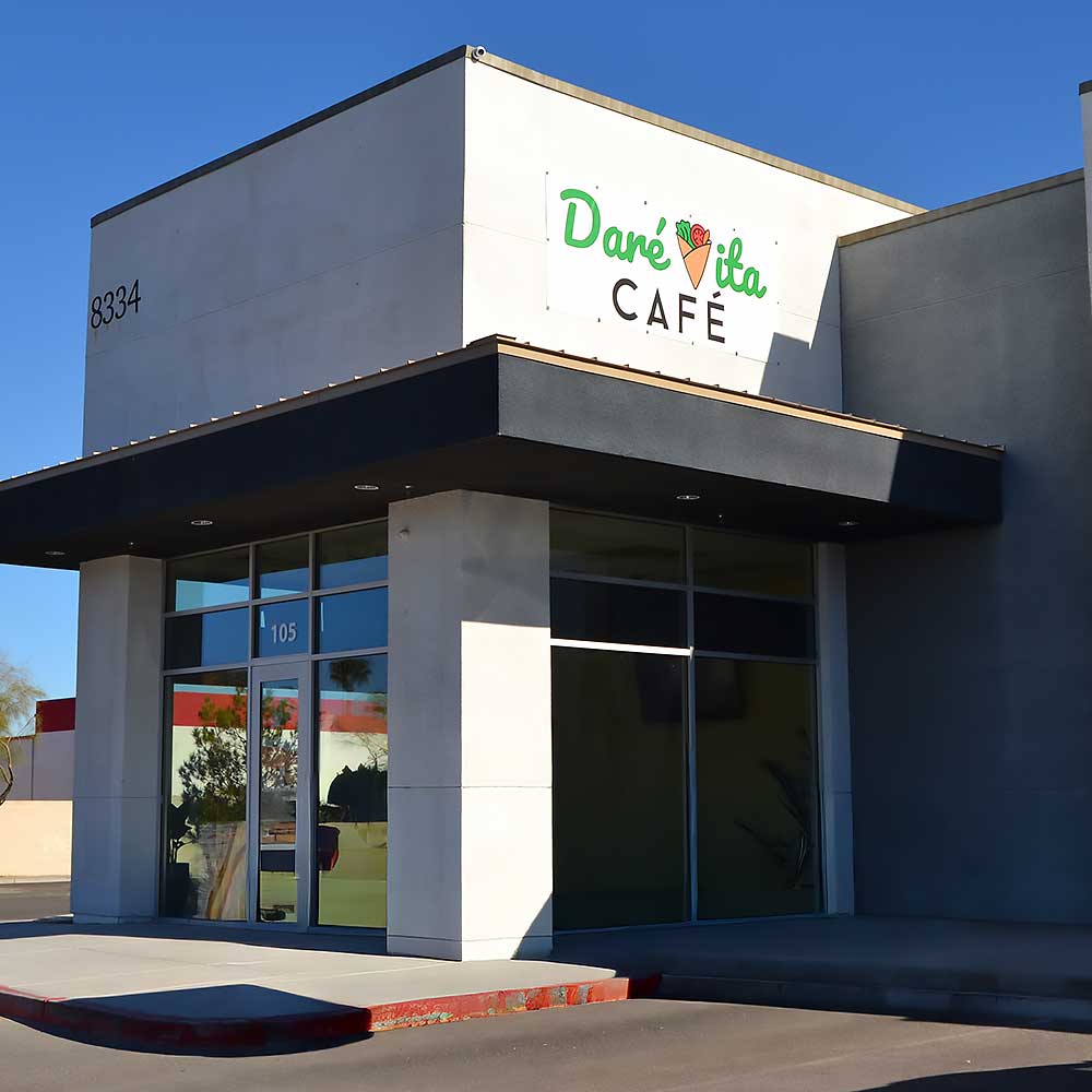 outside-of-building The image shows the exterior of Daré Vita Café, a modern building with large windows and a sign. Specializing in allergen-friendly, gluten-free, and plant-based meals, it offers fresh, vibrant dishes made from natural ingredients.| Daré Vita Café | Las Vegas